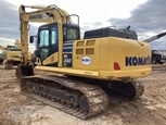 Used Excavator under cloudy sky